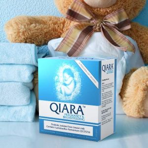 A box of Qiara Pregnancy & Breastfeeding with folded towels and brown teddy bear behind it